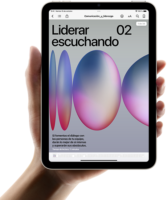 Un usuario sostiene un iPad mini en posición horizontal con una mano. La pantalla muestra la app Libros